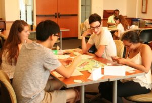 Students playing Monopoly in "Home, Bittersweet Home" AMCS course