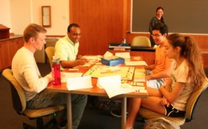 Students play Monopoly in "Home, Bittersweet Home" course, as instructor, Michelle Repice, looks on