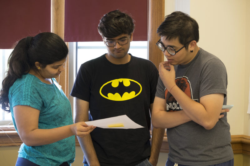 3 graduate students consider a scenario in a workshop