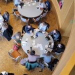 People talking around round tables