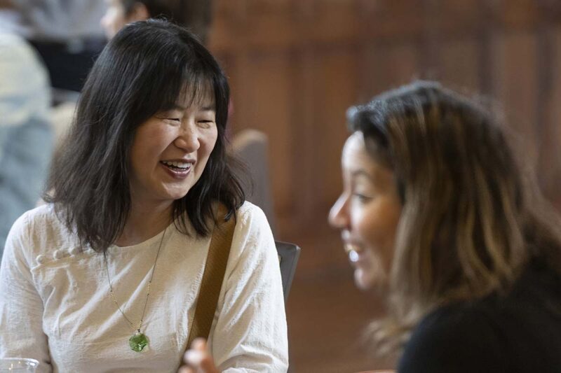 Two women laughing and talking