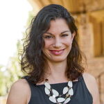 Woman with long black hair smiling
